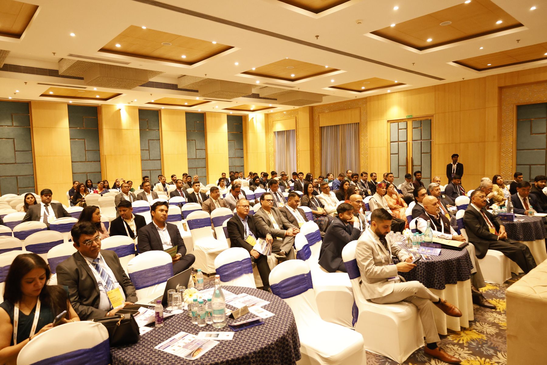 Delegates seated in the conference hall listening to a session